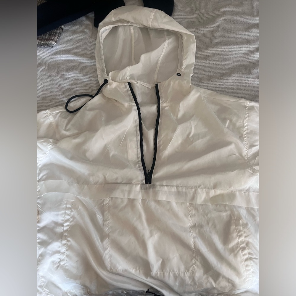 White zip up wind breaker with hood and adjustable strings